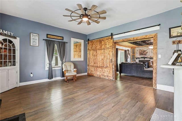 213 N Broadway St, Blanchester, OH 45107 - living room featuring ceiling fan, wood finished floors, and a barn door
