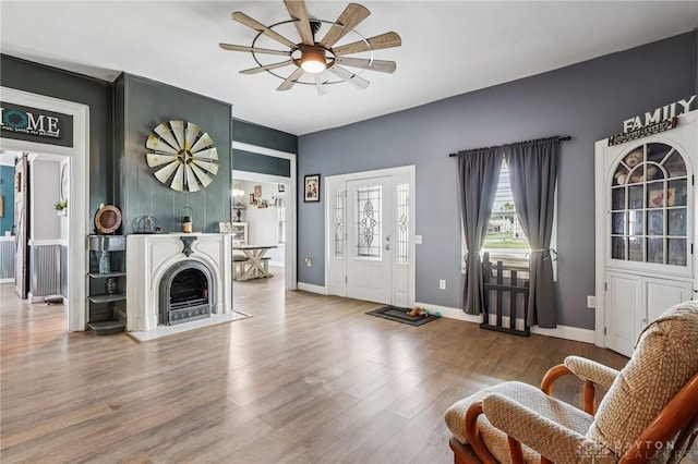 213 N Broadway St, Blanchester, OH 45107 - living area with a ceiling fan, wood finished floors, and a fireplace