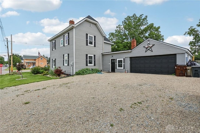 213 N Broadway St, Blanchester, OH 45107 - view of front of house featuring a chimney and driveway