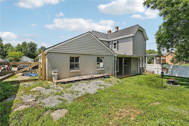 213 N Broadway St, Blanchester, OH 45107 - back of property with a fire pit, a fenced backyard, and a wooden deck