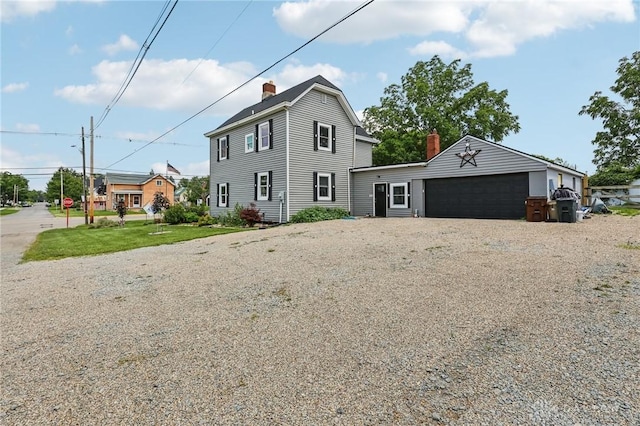 213 N Broadway St, Blanchester, OH 45107 - view of front facade featuring a chimney and a detached garage