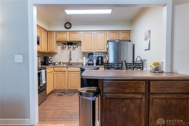 3301 Witherward Trl, Miami Twp, OH 45449 - kitchen with light brown cabinetry, stainless steel range with electric stovetop, dishwasher, backsplash, and light wood-style flooring