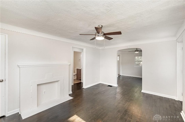 1337 Shepherd Ln, Hamilton, OH 45215 - unfurnished living room featuring ceiling fan, arched walkways, hardwood / wood-style flooring, and a textured ceiling