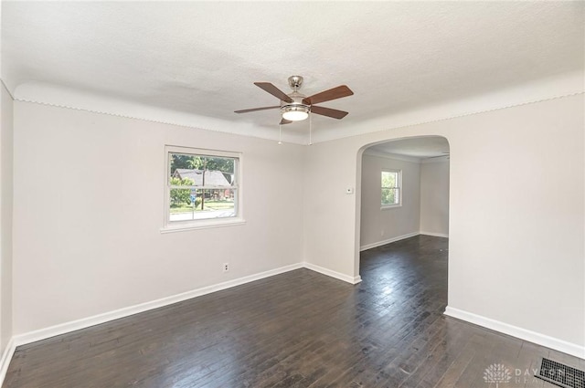 1337 Shepherd Ln, Hamilton, OH 45215 - spare room with arched walkways, plenty of natural light, a ceiling fan, dark wood finished floors, and a textured ceiling