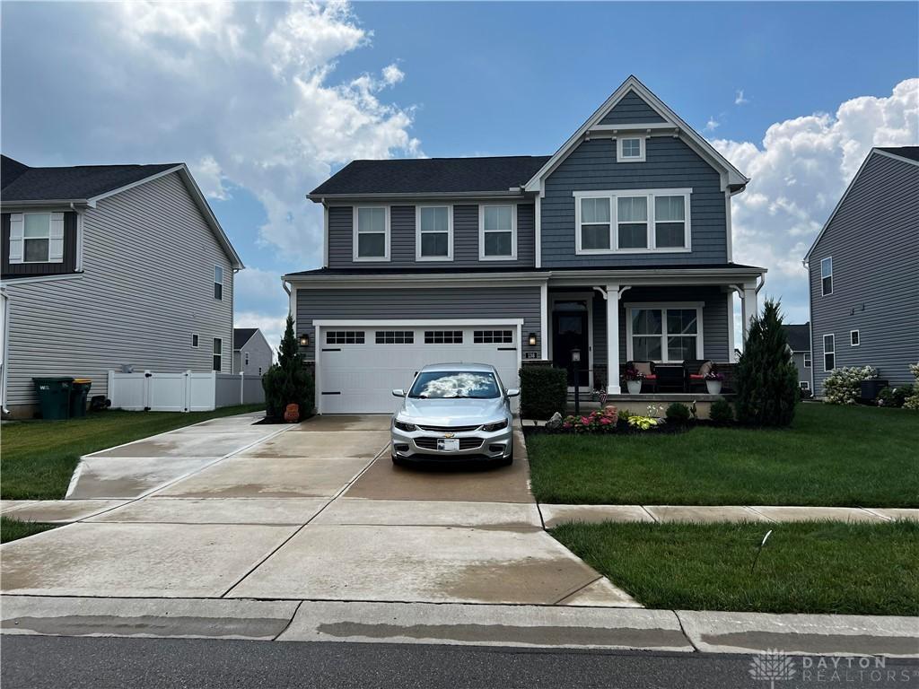138 Ridgebrook Trl, Beavercreek Twp, OH 45385 - view of front facade with covered porch, concrete driveway, and an attached garage