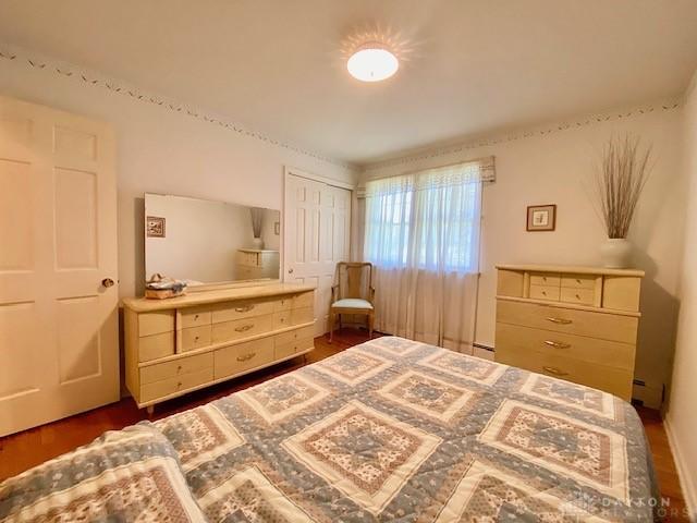 9476 Sheehan Rd, Dayton, OH 45458 - bedroom featuring a closet and dark wood-style floors