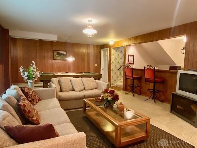 9476 Sheehan Rd, Dayton, OH 45458 - living room featuring carpet flooring, wooden walls, and a bar