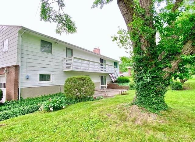 9476 Sheehan Rd, Dayton, OH 45458 - rear view of house featuring a yard, a chimney, and a patio area