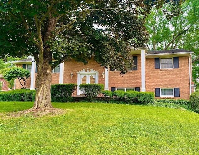 9476 Sheehan Rd, Dayton, OH 45458 - view of front facade with a front yard and brick siding
