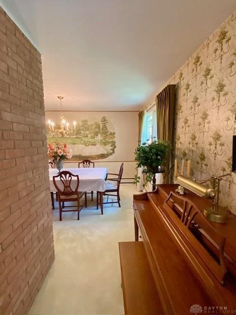 9476 Sheehan Rd, Dayton, OH 45458 - dining space with light colored carpet, a chandelier, and wallpapered walls