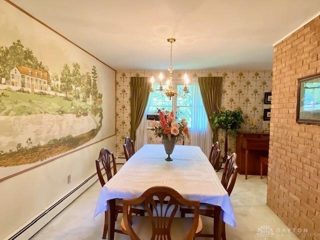 9476 Sheehan Rd, Dayton, OH 45458 - dining space featuring a baseboard radiator, a chandelier, healthy amount of natural light, and wallpapered walls