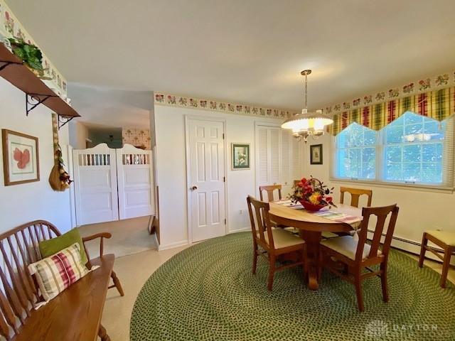 9476 Sheehan Rd, Dayton, OH 45458 - dining space featuring a chandelier and carpet flooring