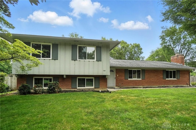 1360 Fenway Ct, Centerville, OH 45458 - split level home featuring a front lawn, a chimney, brick siding, and board and batten siding