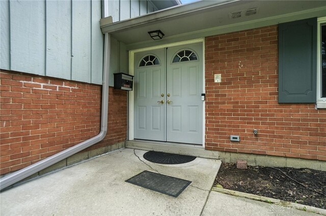 1360 Fenway Ct, Centerville, OH 45458 - view of exterior entry with board and batten siding and brick siding