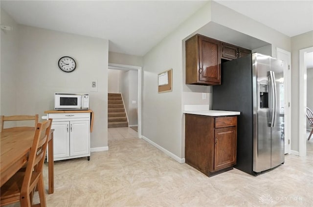1360 Fenway Ct, Centerville, OH 45458 - kitchen with white microwave, stainless steel fridge with ice dispenser, light countertops, and dark brown cabinetry