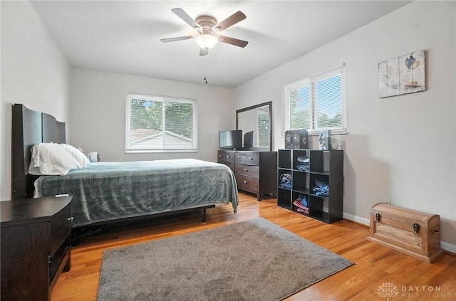 1360 Fenway Ct, Centerville, OH 45458 - bedroom featuring multiple windows, light wood finished floors, and a ceiling fan