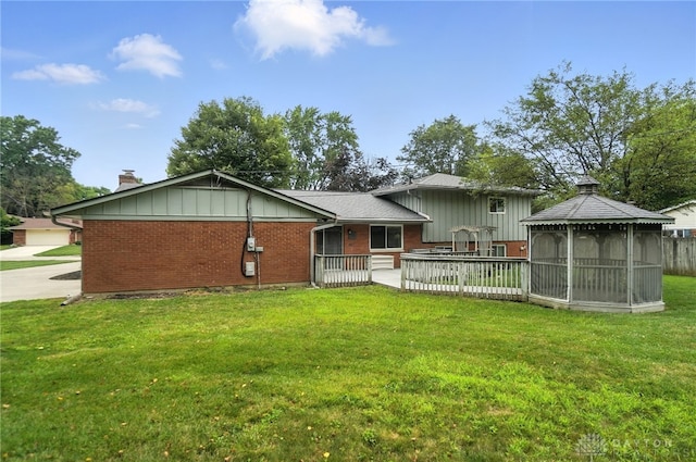 1360 Fenway Ct, Centerville, OH 45458 - back of house with a gazebo, brick siding, a chimney, and a lawn