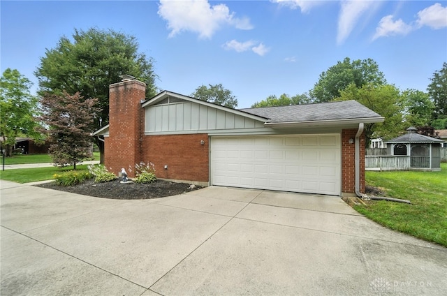 1360 Fenway Ct, Centerville, OH 45458 - view of home's exterior featuring brick siding, driveway, a garage, a gazebo, and a chimney