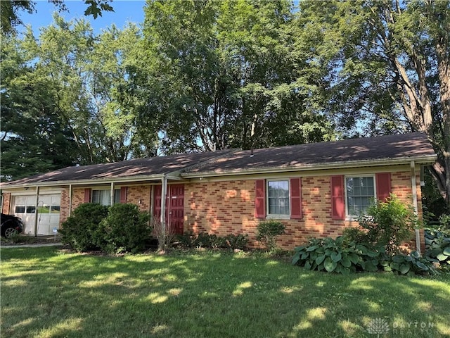 1059 Apollo, Xenia Twp, OH 45385 - view of front of house with an attached garage, a front yard, and brick siding