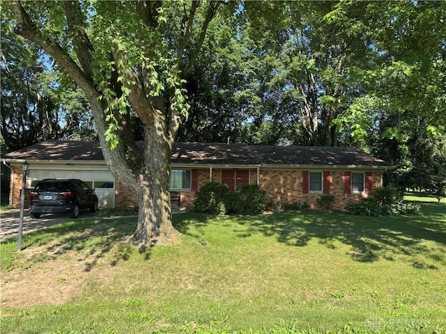 1059 Apollo, Xenia Twp, OH 45385 - ranch-style house featuring an attached garage, a front yard, brick siding, and driveway