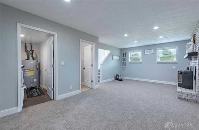 7143 S State Route 123, Blanchester, OH 45107 - basement with water heater, recessed lighting, carpet flooring, stairway, and a wood stove