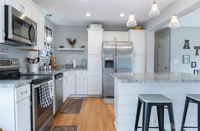 7143 S State Route 123, Blanchester, OH 45107 - kitchen featuring appliances with stainless steel finishes, open shelves, white cabinetry, recessed lighting, and light wood-style floors