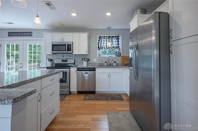 7143 S State Route 123, Blanchester, OH 45107 - kitchen featuring appliances with stainless steel finishes, white cabinets, recessed lighting, and light wood-type flooring