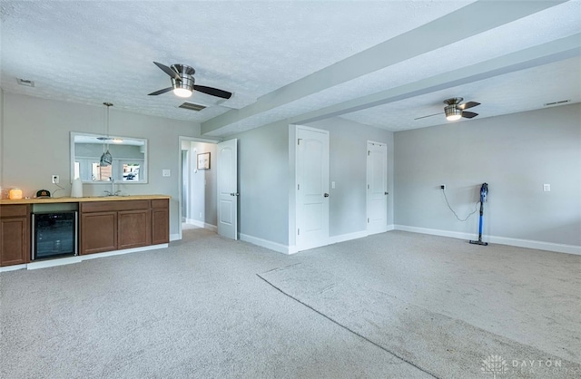 7143 S State Route 123, Blanchester, OH 45107 - unfurnished living room featuring beverage cooler, a ceiling fan, light carpet, and a textured ceiling
