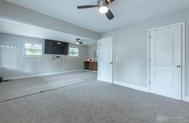 7143 S State Route 123, Blanchester, OH 45107 - unfurnished living room featuring ceiling fan, carpet flooring, and a textured ceiling