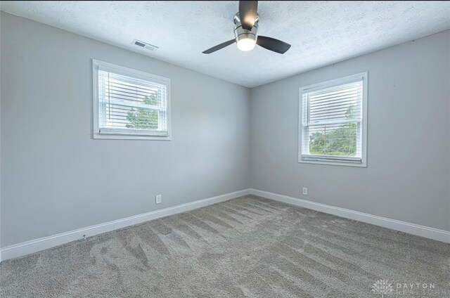 7143 S State Route 123, Blanchester, OH 45107 - spare room featuring a textured ceiling, carpet, and ceiling fan