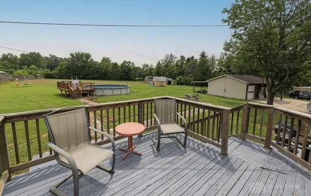 7143 S State Route 123, Blanchester, OH 45107 - deck with an outbuilding, an outdoor pool, and a yard