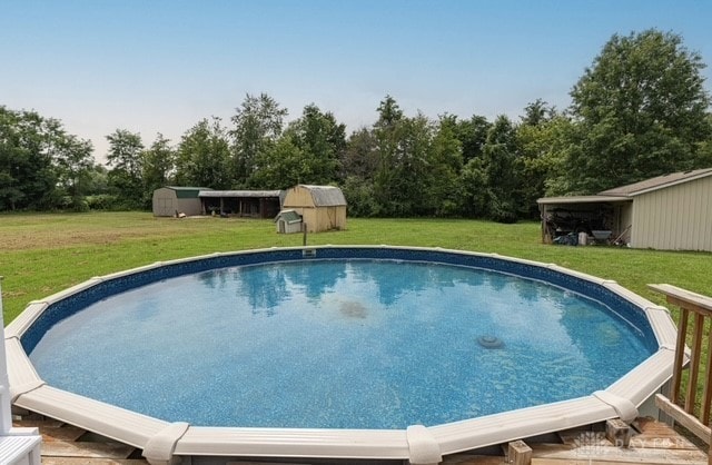 7143 S State Route 123, Blanchester, OH 45107 - outdoor pool with a yard, an outdoor structure, and view of wooded area