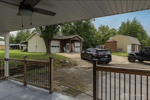 7143 S State Route 123, Blanchester, OH 45107 - view of patio / terrace featuring an outbuilding, a garage, and a ceiling fan