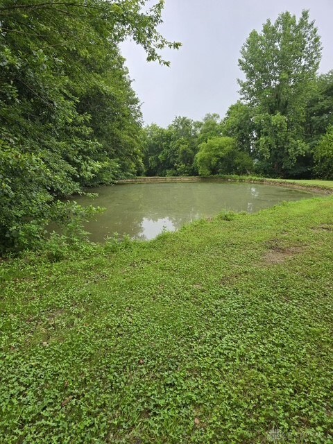 7143 S State Route 123, Blanchester, OH 45107 - water view with a heavily wooded area