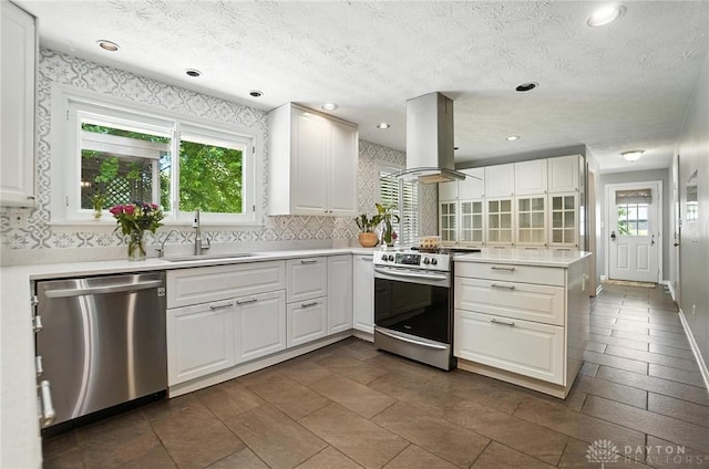 1572 Frontier Ct, Dayton, OH 45458 - kitchen featuring appliances with stainless steel finishes, island range hood, backsplash, white cabinets, and a textured ceiling