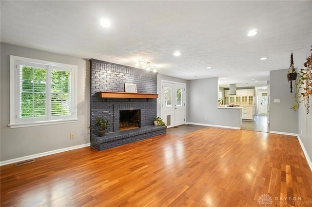 1572 Frontier Ct, Dayton, OH 45458 - unfurnished living room with wood finished floors, recessed lighting, and a fireplace