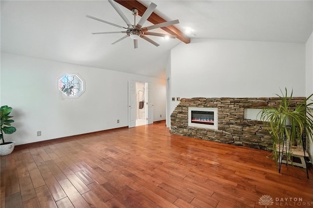 1572 Frontier Ct, Dayton, OH 45458 - unfurnished living room featuring ceiling fan, beamed ceiling, a stone fireplace, wood finished floors, and high vaulted ceiling