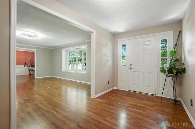 1572 Frontier Ct, Dayton, OH 45458 - foyer entrance featuring healthy amount of natural light, wood finished floors, a textured ceiling, and ornamental molding