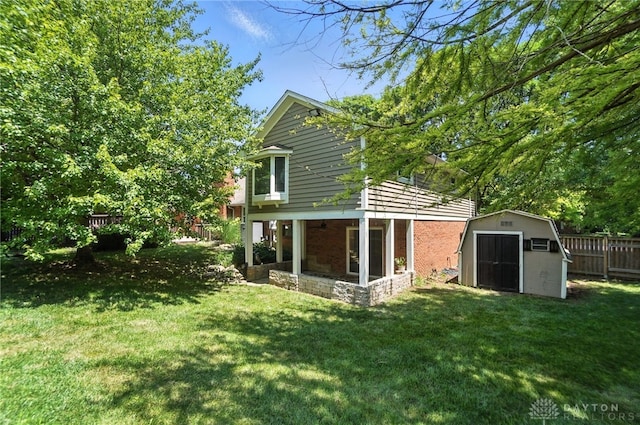 1572 Frontier Ct, Dayton, OH 45458 - back of house with a storage shed, ceiling fan, and brick siding