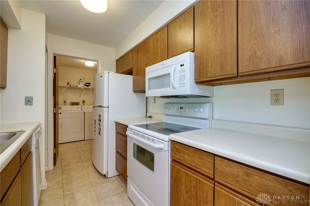 1311 Hollow Run Unit 6, Dayton, OH 45459 - kitchen with white appliances, washer and clothes dryer, brown cabinets, light countertops, and light tile patterned floors