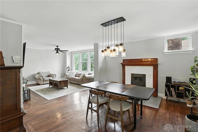 2594 Laura Ln, Norwood, OH 45212 - dining space featuring a fireplace, ceiling fan, wood finished floors, and ornamental molding