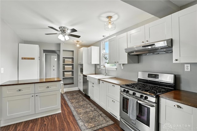 2594 Laura Ln, Norwood, OH 45212 - kitchen featuring appliances with stainless steel finishes, under cabinet range hood, butcher block countertops, dark wood-style floors, and ceiling fan
