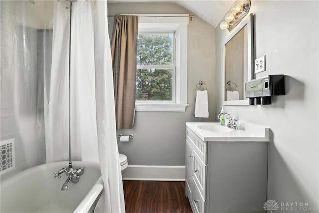 2594 Laura Ln, Norwood, OH 45212 - full bath with a tub to relax in, vanity, wood finished floors, vaulted ceiling, and a shower with curtain