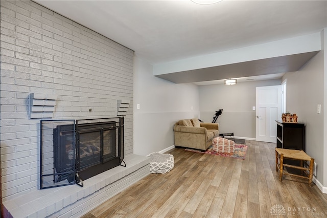 1817 El Camino Dr, Xenia, OH 45385 - living room featuring wood finished floors and a brick fireplace