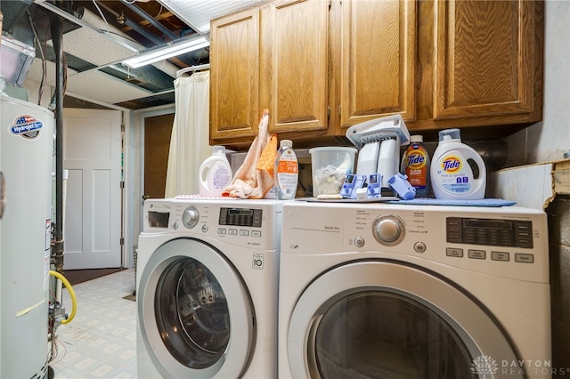 1817 El Camino Dr, Xenia, OH 45385 - laundry area featuring gas water heater, washer and dryer, and cabinet space