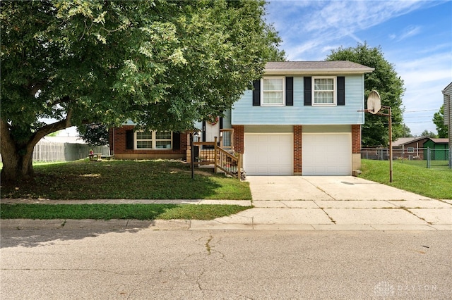 1817 El Camino Dr, Xenia, OH 45385 - view of front of house featuring concrete driveway, a garage, and brick siding