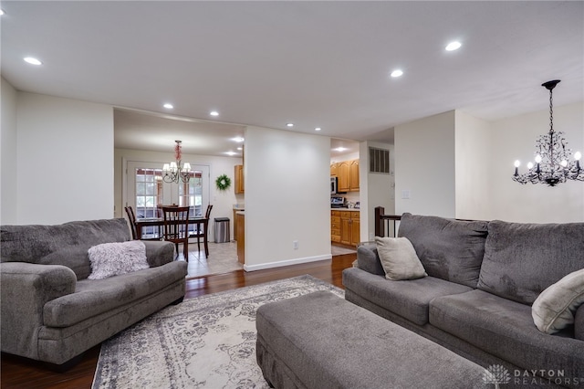 1817 El Camino Dr, Xenia, OH 45385 - living room featuring a chandelier, dark wood finished floors, and recessed lighting