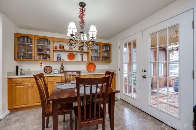1817 El Camino Dr, Xenia, OH 45385 - dining room with french doors, a chandelier, and light tile patterned floors