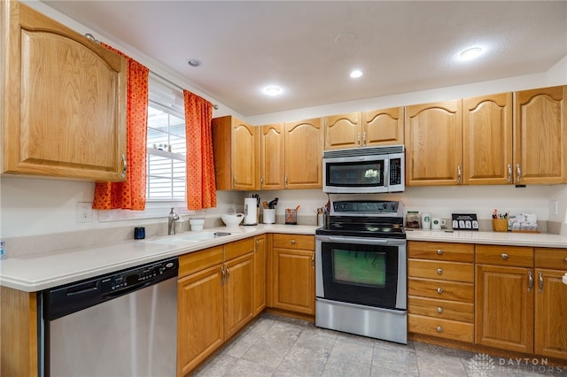 1817 El Camino Dr, Xenia, OH 45385 - kitchen featuring stainless steel appliances, light countertops, recessed lighting, and brown cabinets