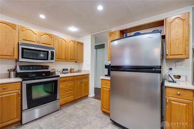 1817 El Camino Dr, Xenia, OH 45385 - kitchen featuring stainless steel appliances, light countertops, and recessed lighting